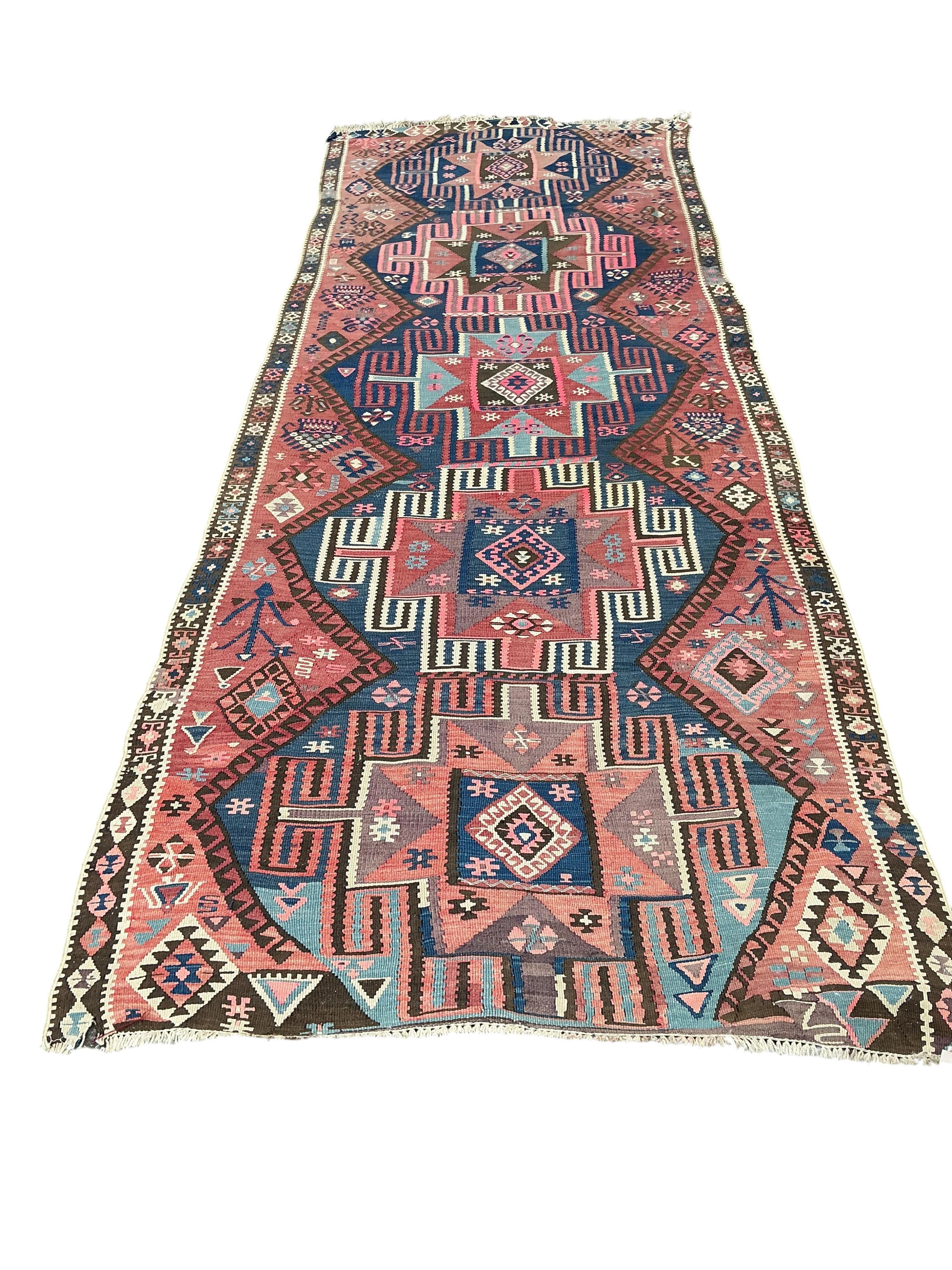 An early 20th century Turkish red ground flat weave Kilim runner, 430 x 138cm